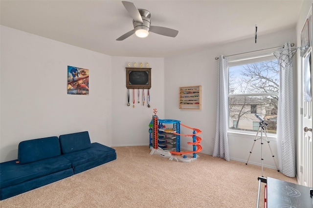 rec room with a ceiling fan, baseboards, and carpet flooring