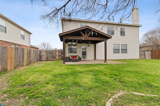 rear view of property featuring a gate, a patio area, a lawn, and a fenced backyard