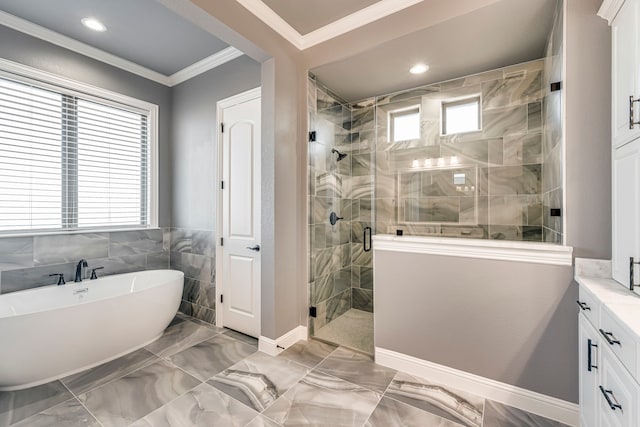 bathroom featuring a soaking tub, marble finish floor, crown molding, a shower stall, and a wealth of natural light