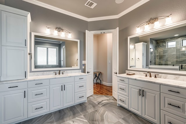 bathroom with two vanities, a sink, visible vents, and crown molding