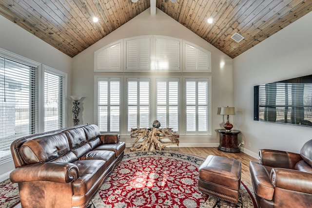 living area with high vaulted ceiling, wooden ceiling, wood finished floors, and a healthy amount of sunlight