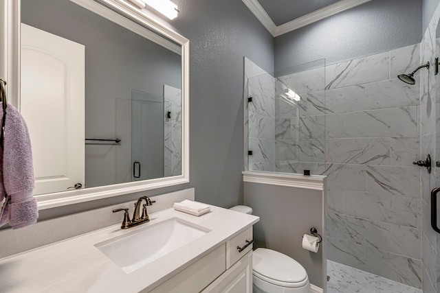 full bathroom with a marble finish shower, a textured wall, toilet, crown molding, and vanity