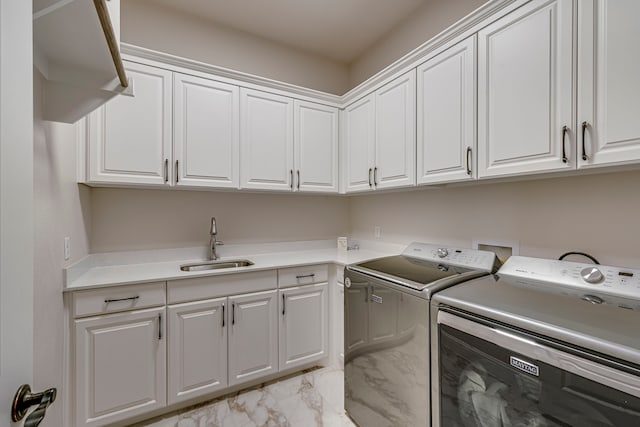 laundry room with marble finish floor, washer and clothes dryer, a sink, and cabinet space