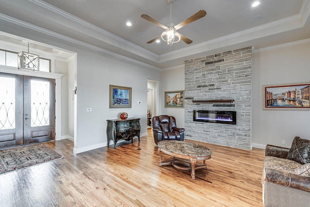 living room with crown molding and wood finished floors