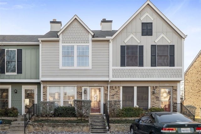 multi unit property with board and batten siding and a chimney