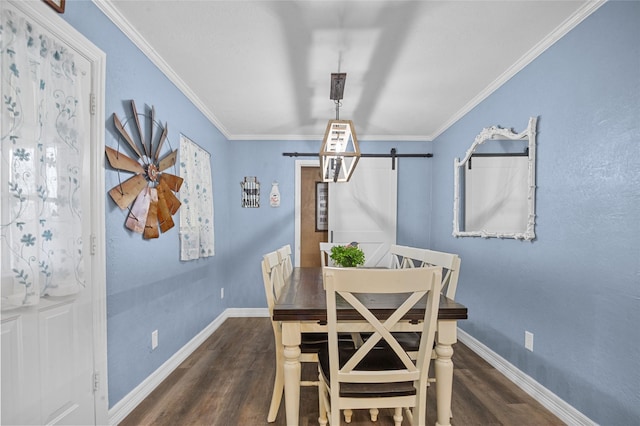 dining area with a barn door, crown molding, baseboards, and dark wood-type flooring