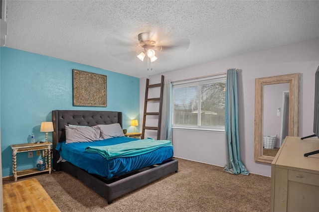 bedroom featuring a ceiling fan, carpet, and a textured ceiling