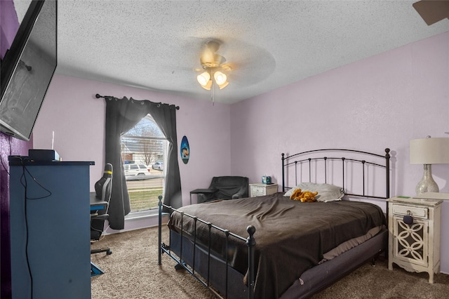 bedroom featuring carpet, ceiling fan, and a textured ceiling