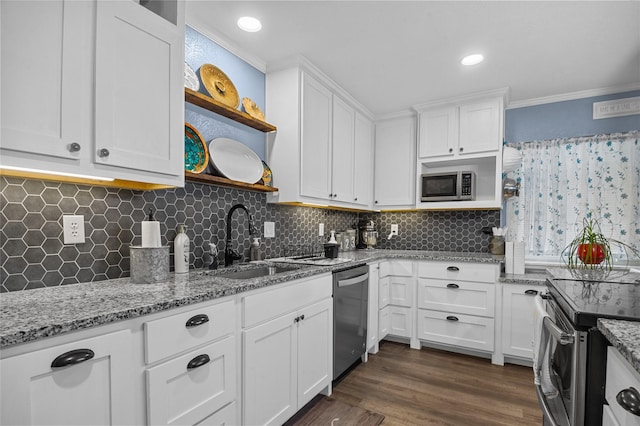 kitchen with white cabinets, ornamental molding, stainless steel appliances, open shelves, and a sink