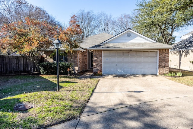 ranch-style home with driveway, brick siding, a front lawn, and an attached garage