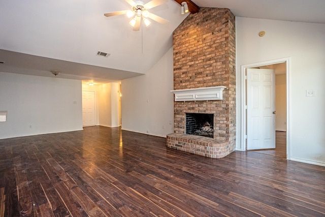 unfurnished living room with visible vents, dark wood finished floors, a ceiling fan, beamed ceiling, and a fireplace