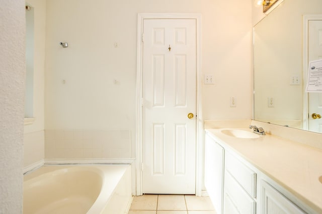 bathroom with a garden tub, double vanity, tile patterned flooring, and a sink