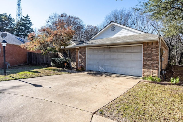 ranch-style house with a garage, concrete driveway, brick siding, and fence