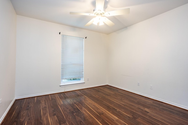 unfurnished room featuring ceiling fan, baseboards, and dark wood finished floors