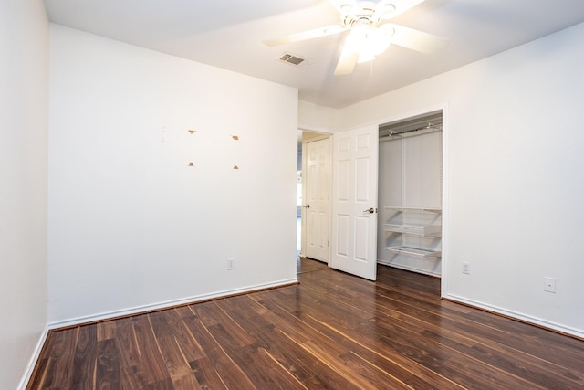 unfurnished bedroom featuring dark wood-style floors, baseboards, and visible vents