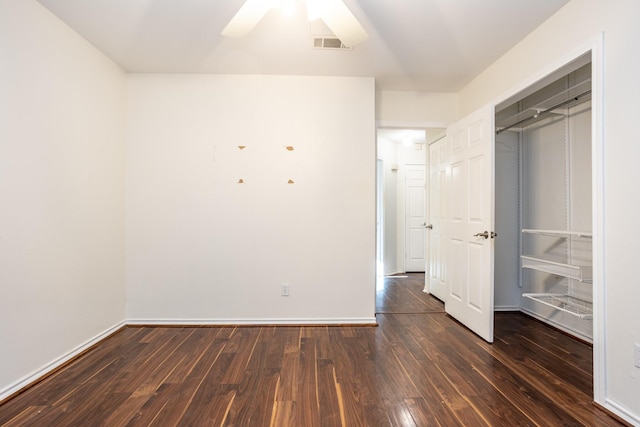 unfurnished bedroom with a ceiling fan, dark wood finished floors, visible vents, and baseboards