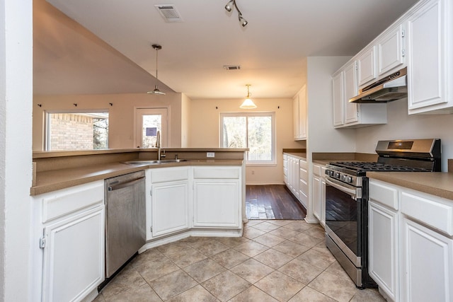 kitchen featuring decorative light fixtures, stainless steel appliances, white cabinetry, a sink, and under cabinet range hood