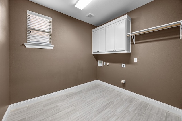 clothes washing area with visible vents, baseboards, gas dryer hookup, and electric dryer hookup