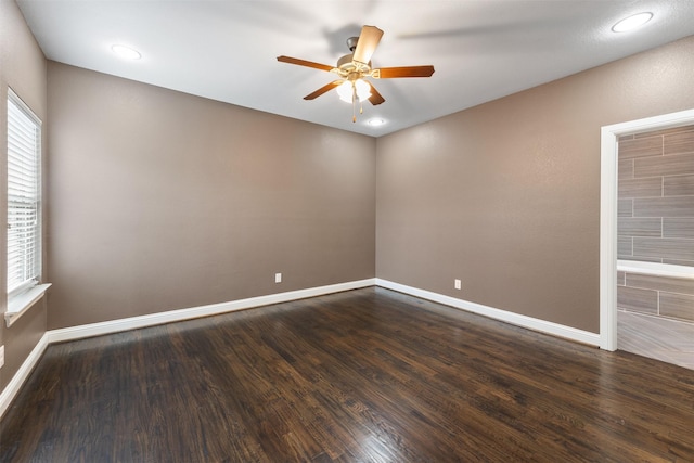 spare room featuring ceiling fan, baseboards, dark wood finished floors, and recessed lighting