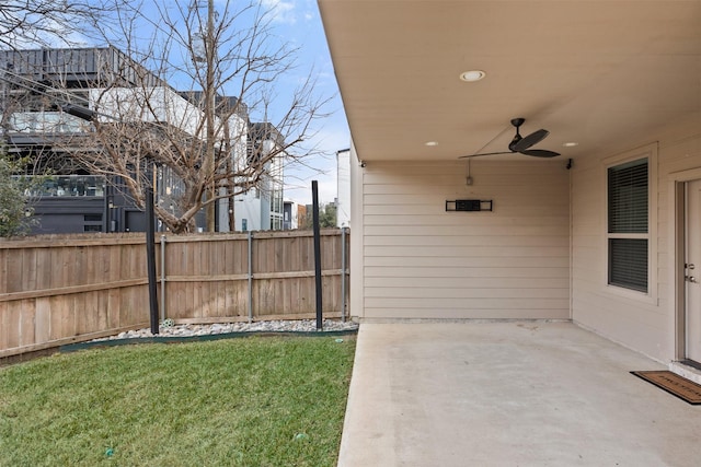 view of yard with a patio area, ceiling fan, and fence