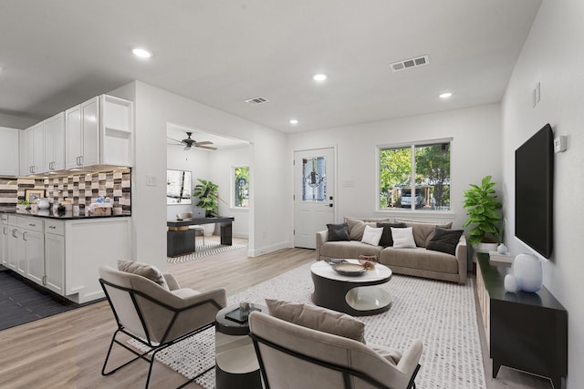 living area featuring recessed lighting, visible vents, and light wood-style floors