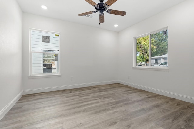 spare room with light wood finished floors and baseboards