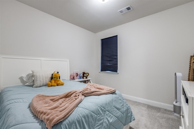 bedroom with light carpet, visible vents, and baseboards