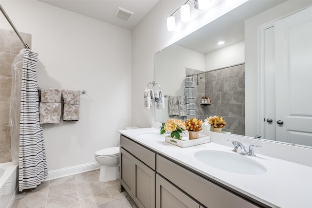 full bathroom with double vanity, visible vents, toilet, a sink, and baseboards