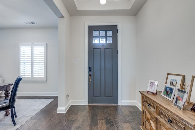 entryway featuring dark wood-style flooring, visible vents, and baseboards