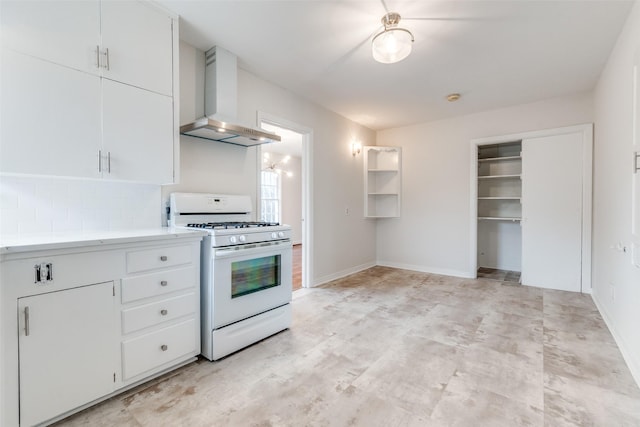 kitchen with tasteful backsplash, baseboards, wall chimney range hood, light countertops, and white gas range