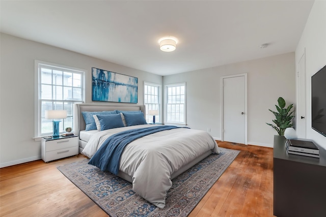 bedroom with wood finished floors and baseboards