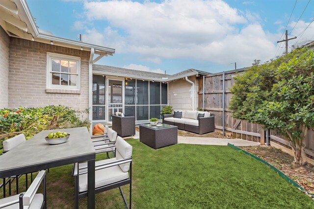 view of yard with a sunroom, a patio, an outdoor hangout area, and a fenced backyard