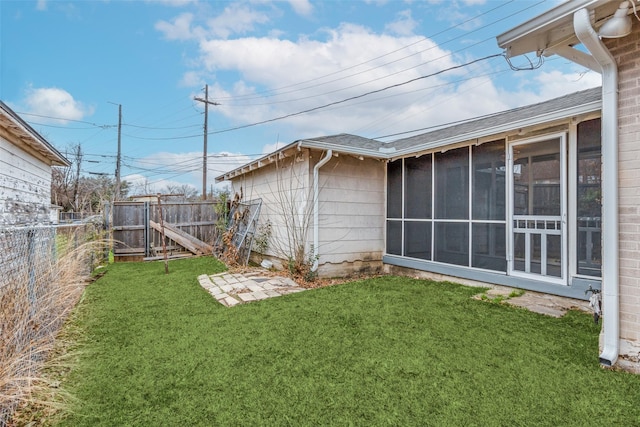 view of yard with a fenced backyard and a sunroom