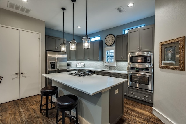 2111 Albany St, Dallas, TX 75201 - kitchen with dark wood-style floors, a sink, a center island, visible vents, and appliances with stainless steel finishes