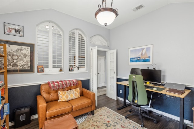 office featuring dark wood-type flooring, lofted ceiling, visible vents, and baseboards