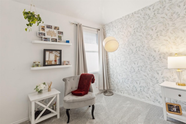 sitting room with carpet, baseboards, and wallpapered walls