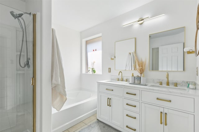 bathroom with a stall shower, a garden tub, a sink, and tile patterned floors