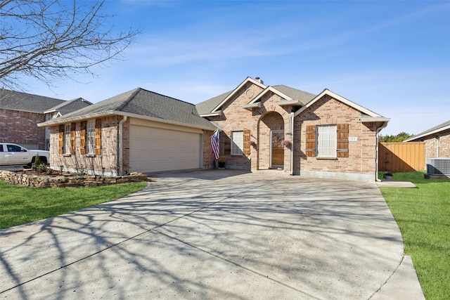 single story home featuring a garage, concrete driveway, brick siding, and a shingled roof