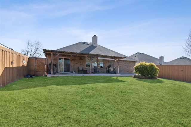 rear view of house featuring a patio area, a fenced backyard, and a yard