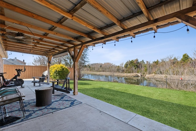 view of patio / terrace with a water view and a fenced backyard