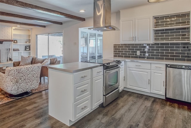 kitchen with a peninsula, island range hood, stainless steel appliances, and white cabinets