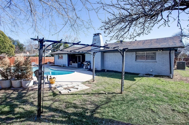 back of house featuring central AC unit, brick siding, fence, a fenced in pool, and a pergola