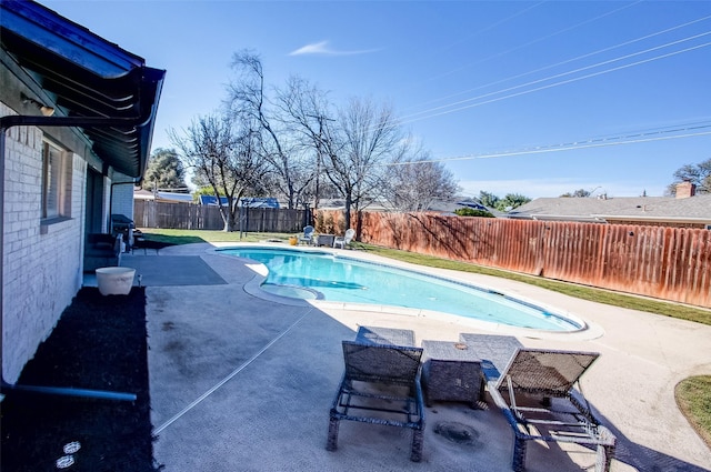 view of swimming pool featuring a fenced backyard, a fenced in pool, and a patio