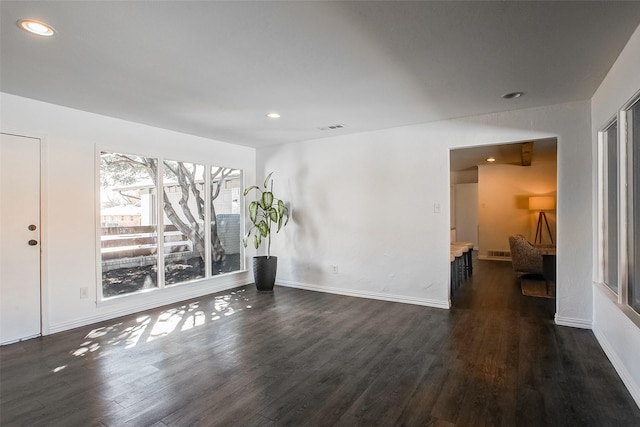 interior space featuring recessed lighting, dark wood-style flooring, and visible vents