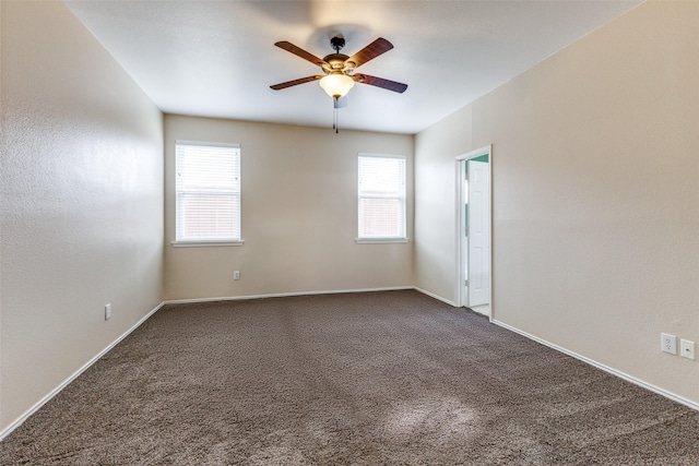 empty room featuring carpet flooring, a ceiling fan, and baseboards