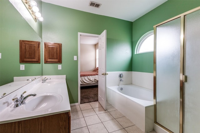 ensuite bathroom featuring visible vents, connected bathroom, a sink, tile patterned flooring, and a bath