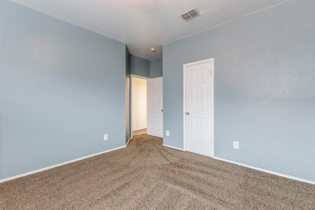 unfurnished bedroom with carpet, visible vents, and baseboards