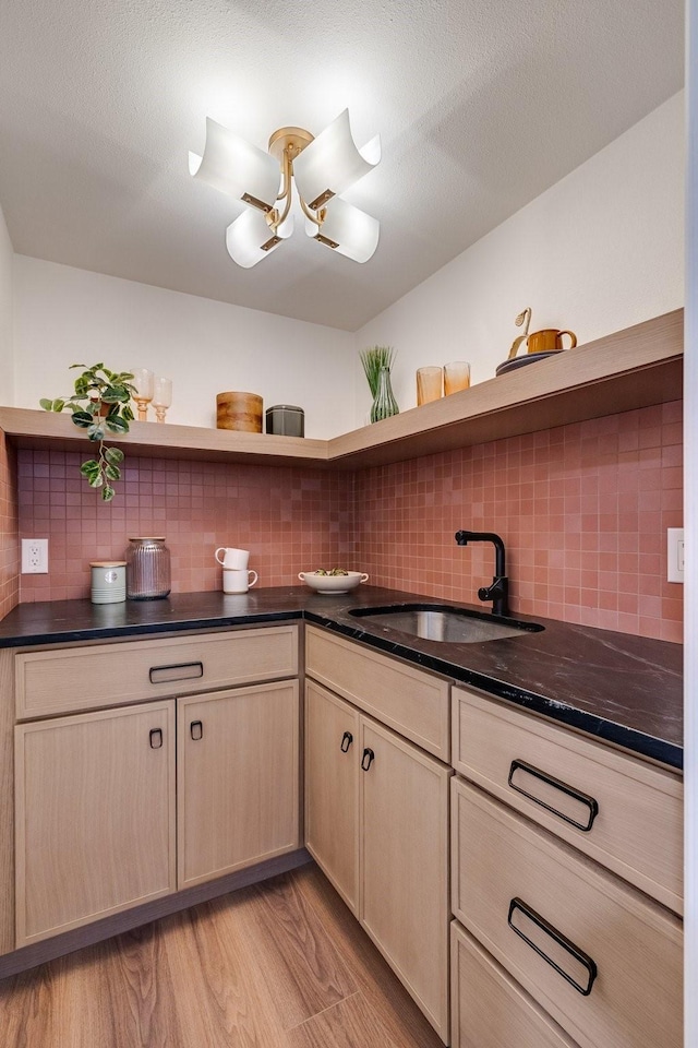 4707 Weyhill Dr, Arlington, TX 76013 - kitchen featuring open shelves, a sink, tasteful backsplash, and light wood-style floors