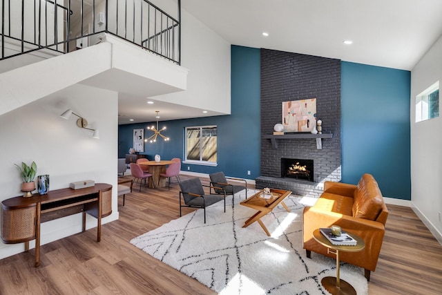 4707 Weyhill Dr, Arlington, TX 76013 - living area featuring high vaulted ceiling, wood finished floors, baseboards, a chandelier, and a brick fireplace