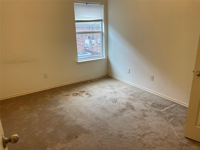 spare room featuring light colored carpet